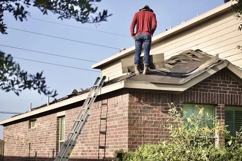 Professional roofer working on a residential roof in Downtown Fort Worth